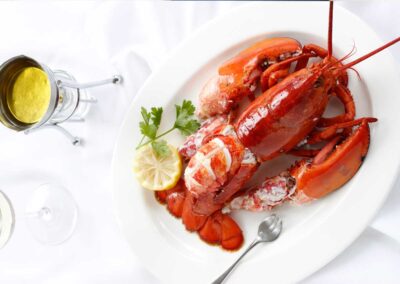 Whole Lobster on white plate with butter